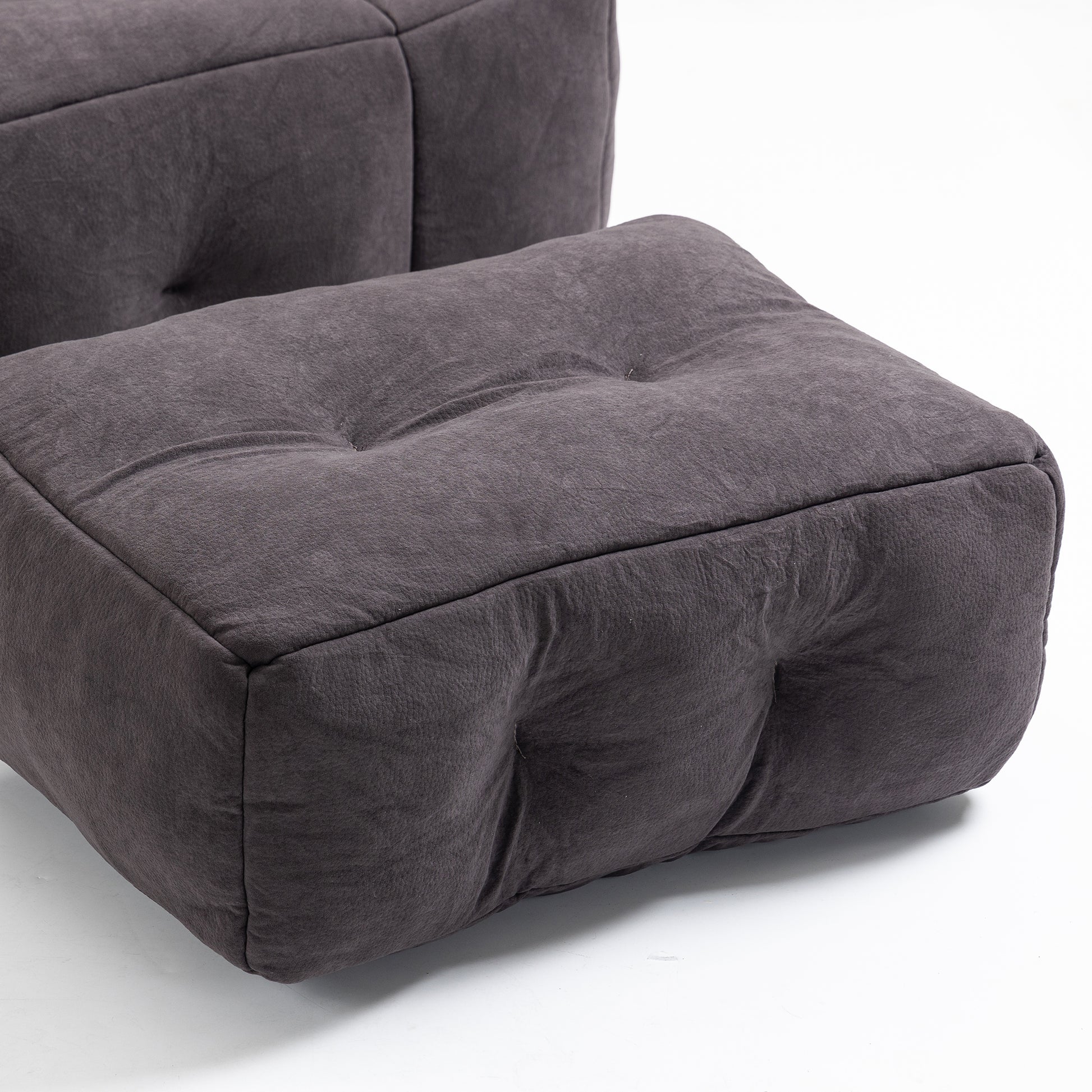 Tufted dark grey fabric ottoman with button details for modern living room comfort
