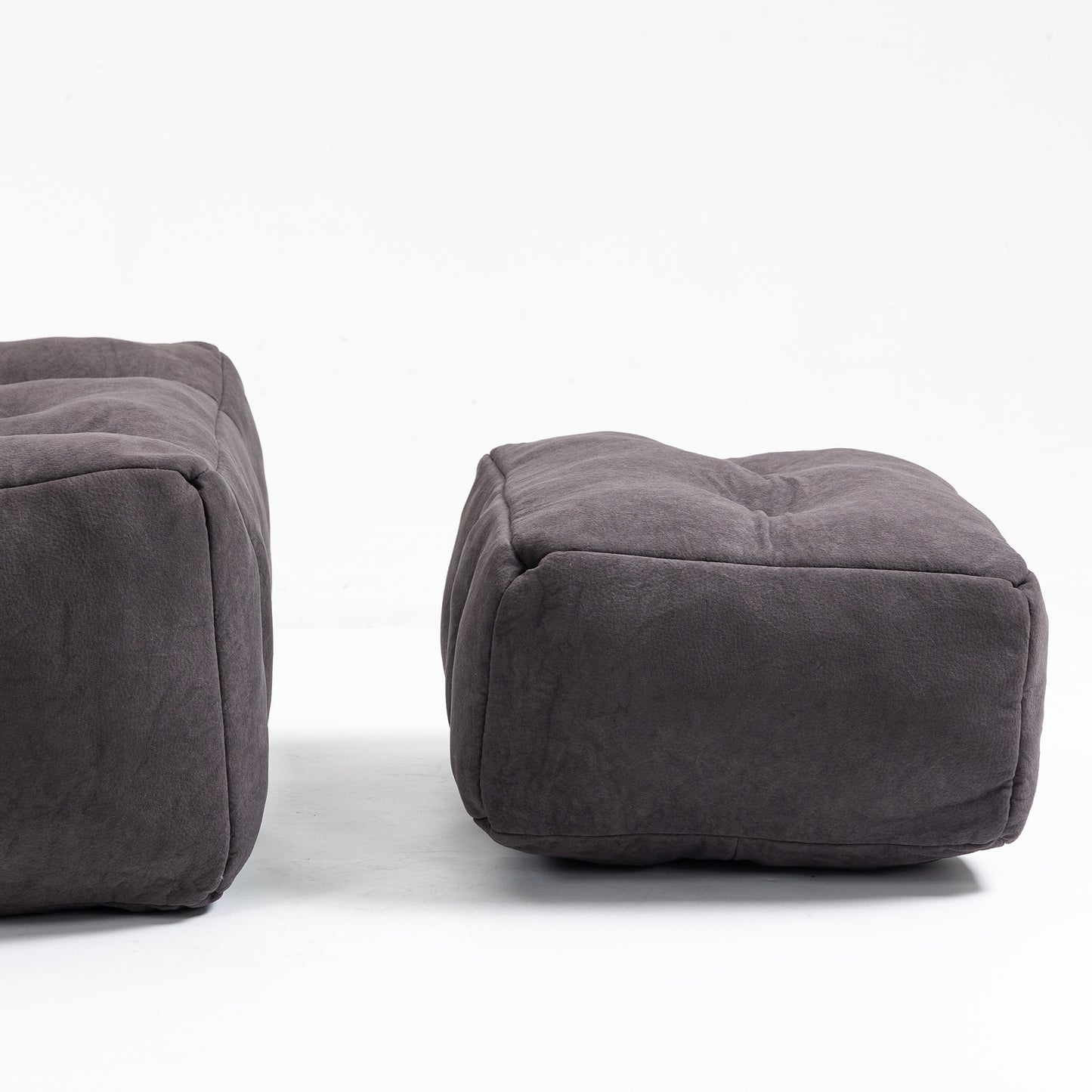 Dark grey tufted fabric ottoman with a textured finish perfect for living room seating