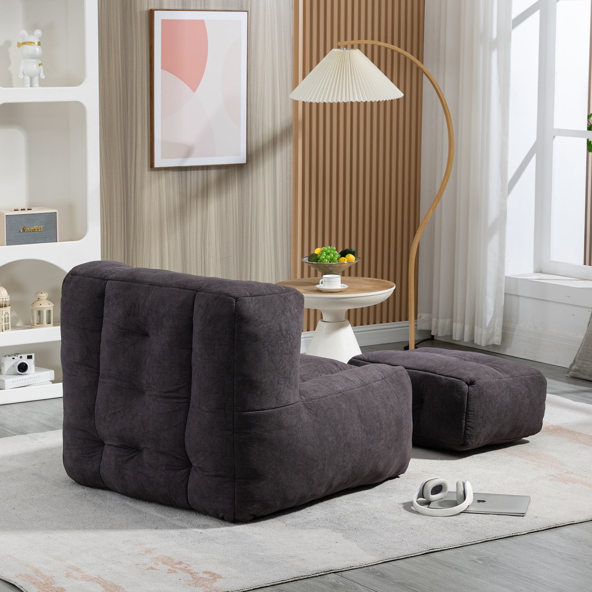 Dark gray tufted upholstered sofa with a matching ottoman modern living room furniture