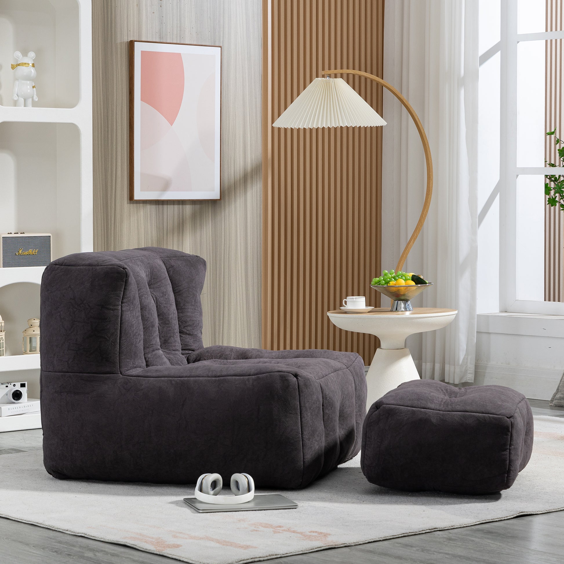 Dark gray corduroy bean bag chair with matching ottoman and plush cushioning
