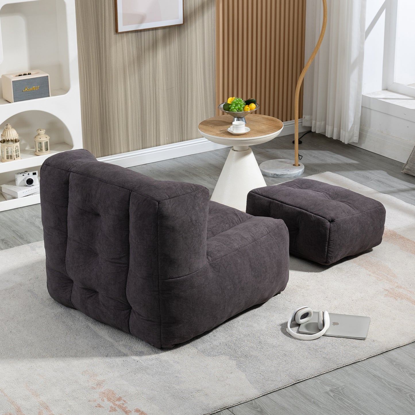 Dark grey tufted fabric armchair with a matching footrest comfortable modern seating option
