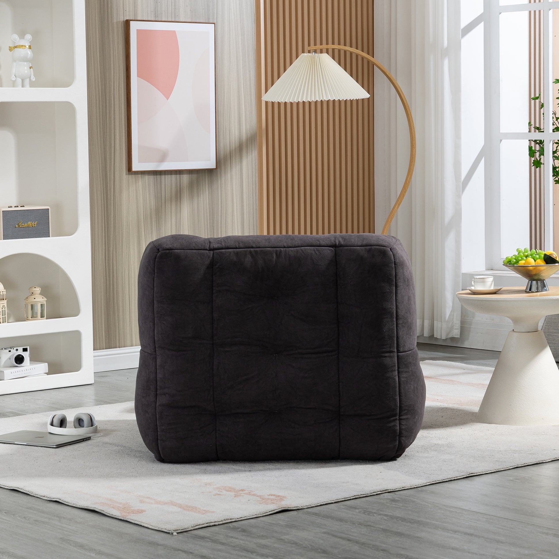 Dark gray upholstered cube ottoman with quilted detail perfect for living rooms