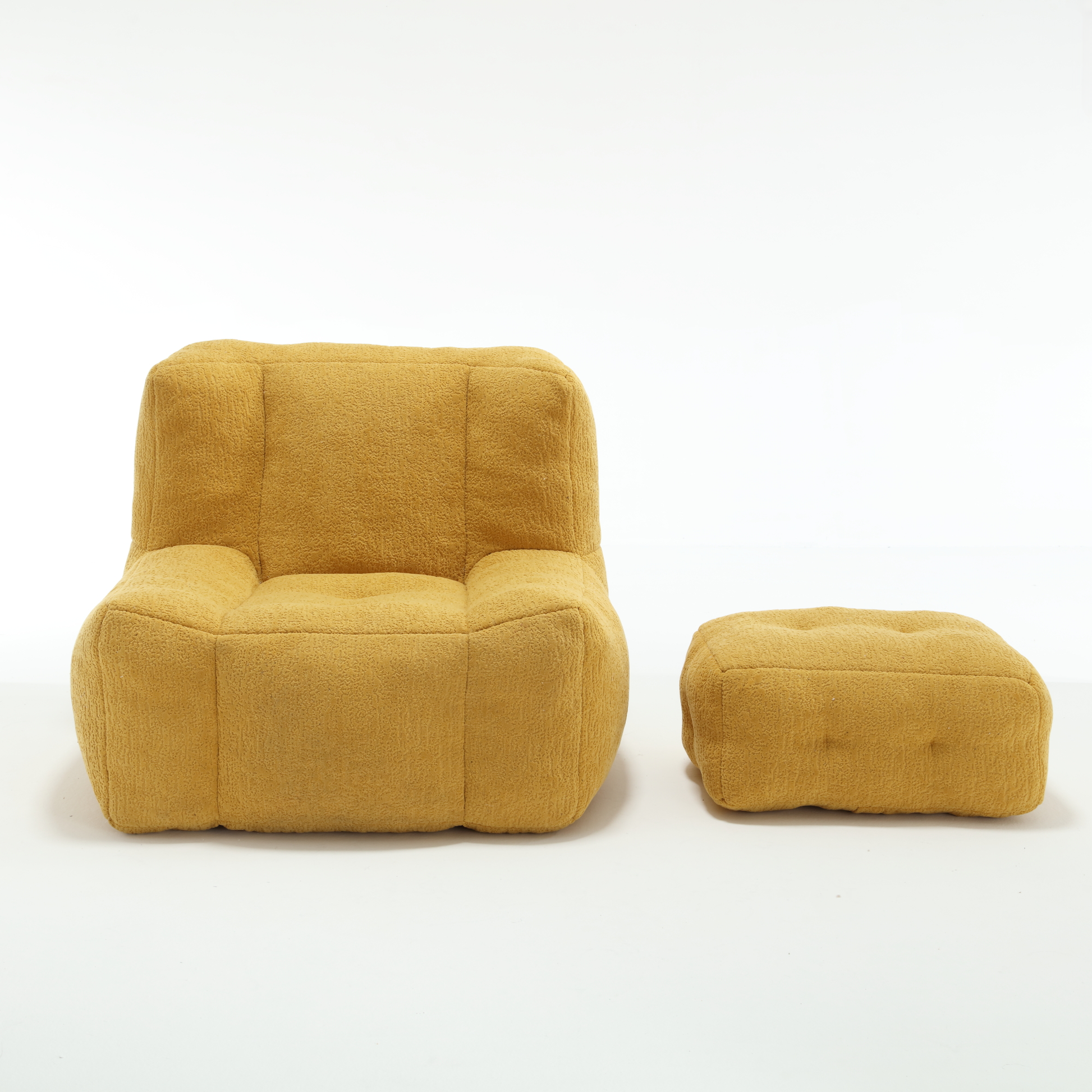 Yellow textured fabric armchair with rounded edges and matching ottoman