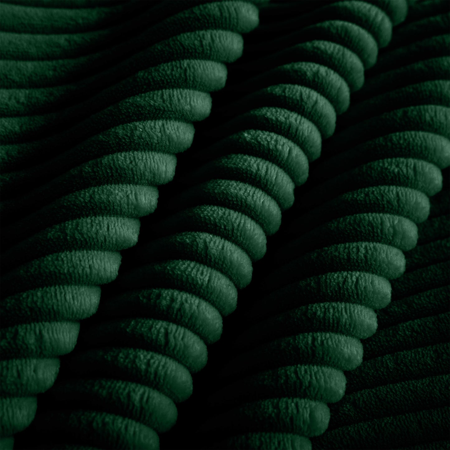 Deep green corduroy fabric texture with raised wales and plush feel