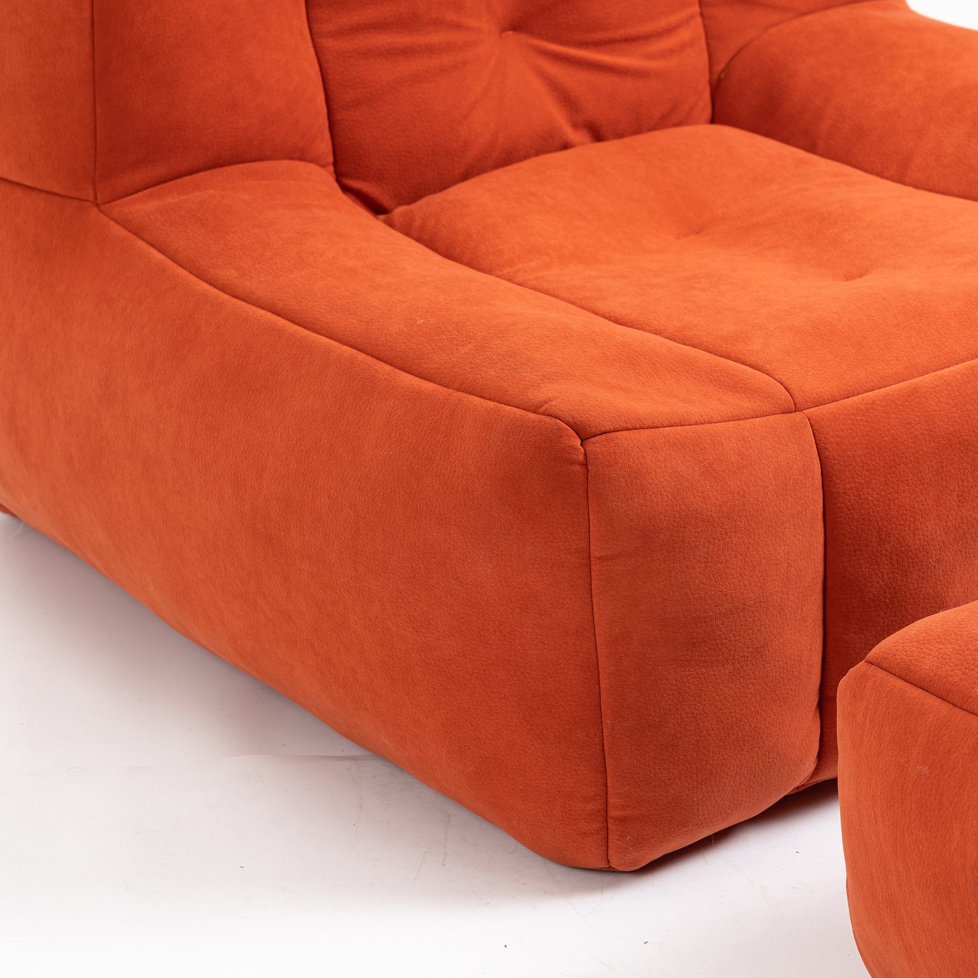 Orange fabric modular sofa section plush texture and tufted back detail