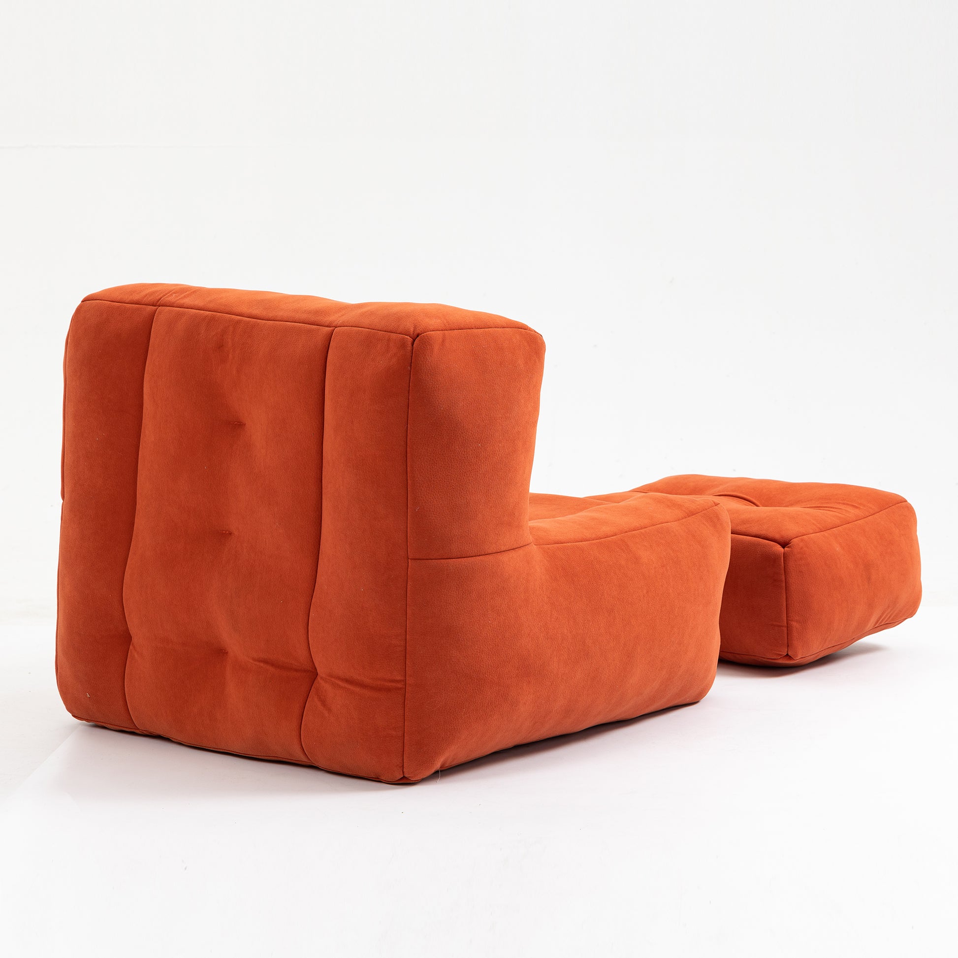 Orange modular sofa sectional with tufted seating and ottoman