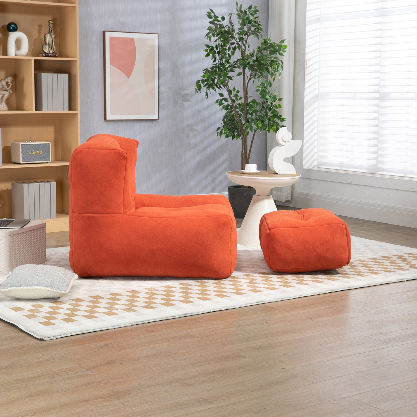 Modern orange bean bag chair with matching ottoman on a geometric rug