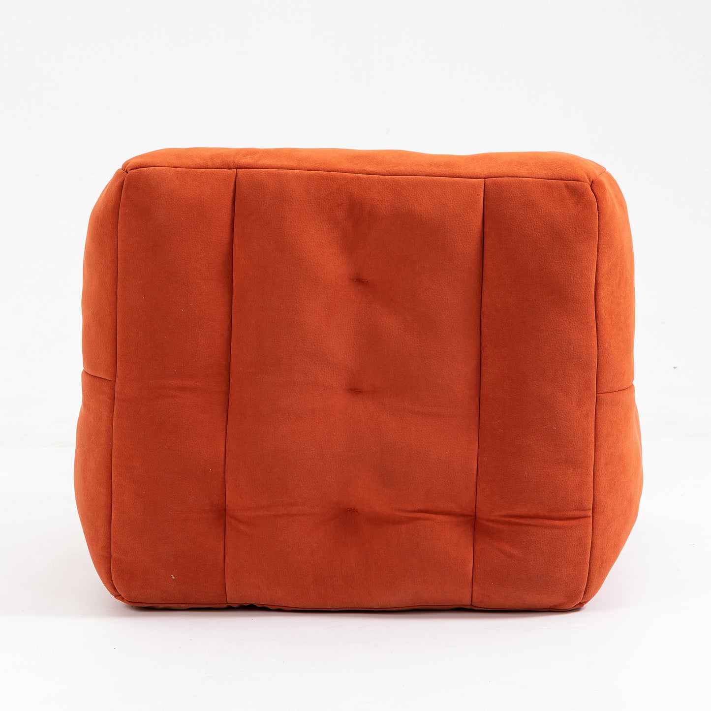 Tufted burnt orange ottoman with soft fabric texture for comfortable seating