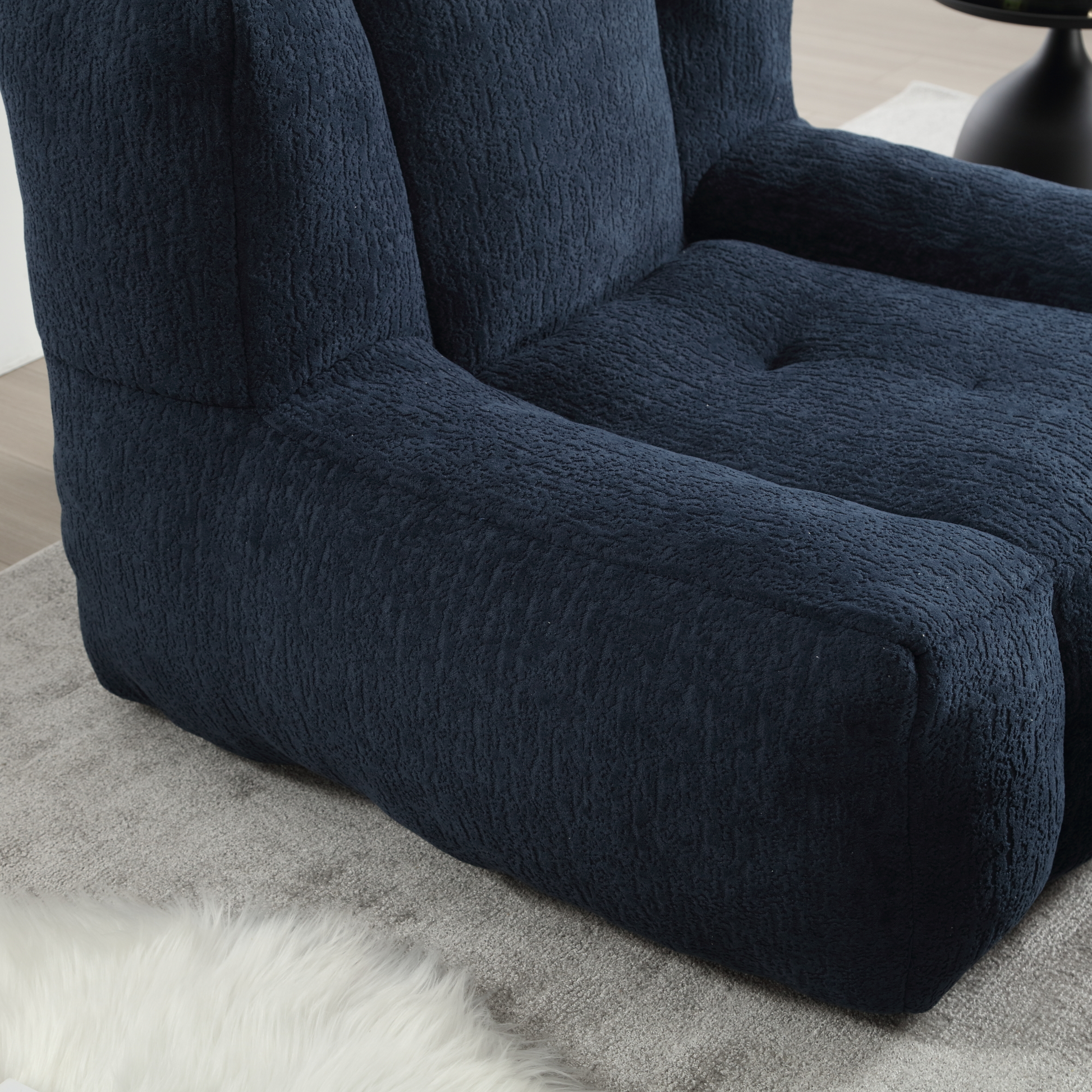 Textured navy blue accent chair with plush boucle upholstery for a cozy living room