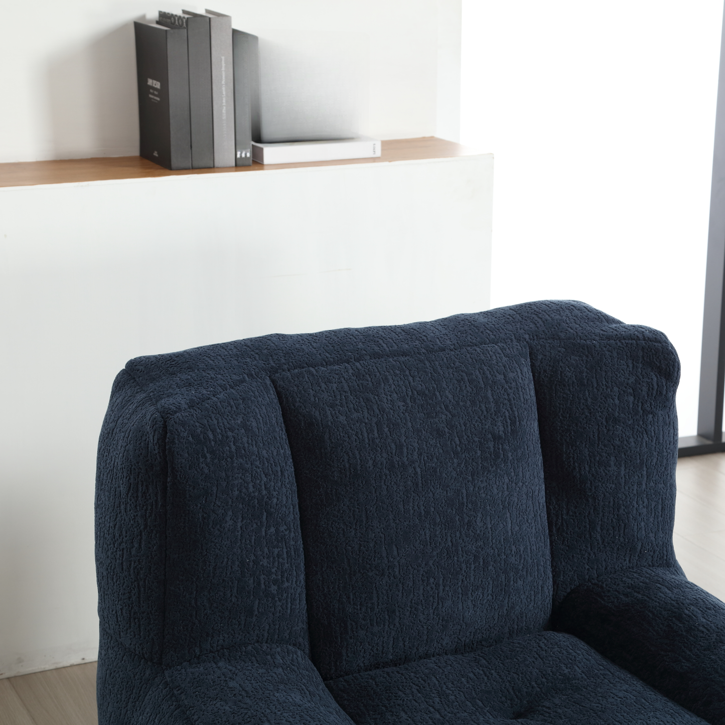 Closeup of textured navy blue armchair upholstery showcasing comfort