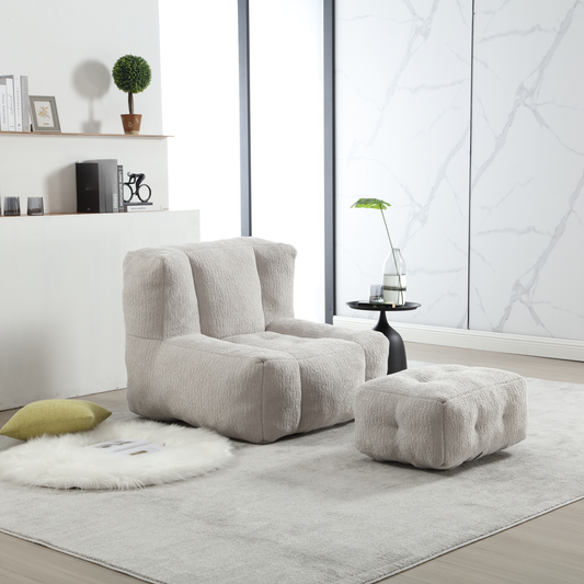 Plush light grey boucle armchair with matching tufted ottoman for ultimate comfort