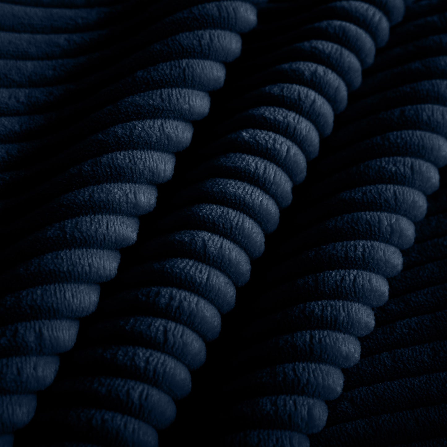 Dark navy corduroy fabric texture with pronounced wales