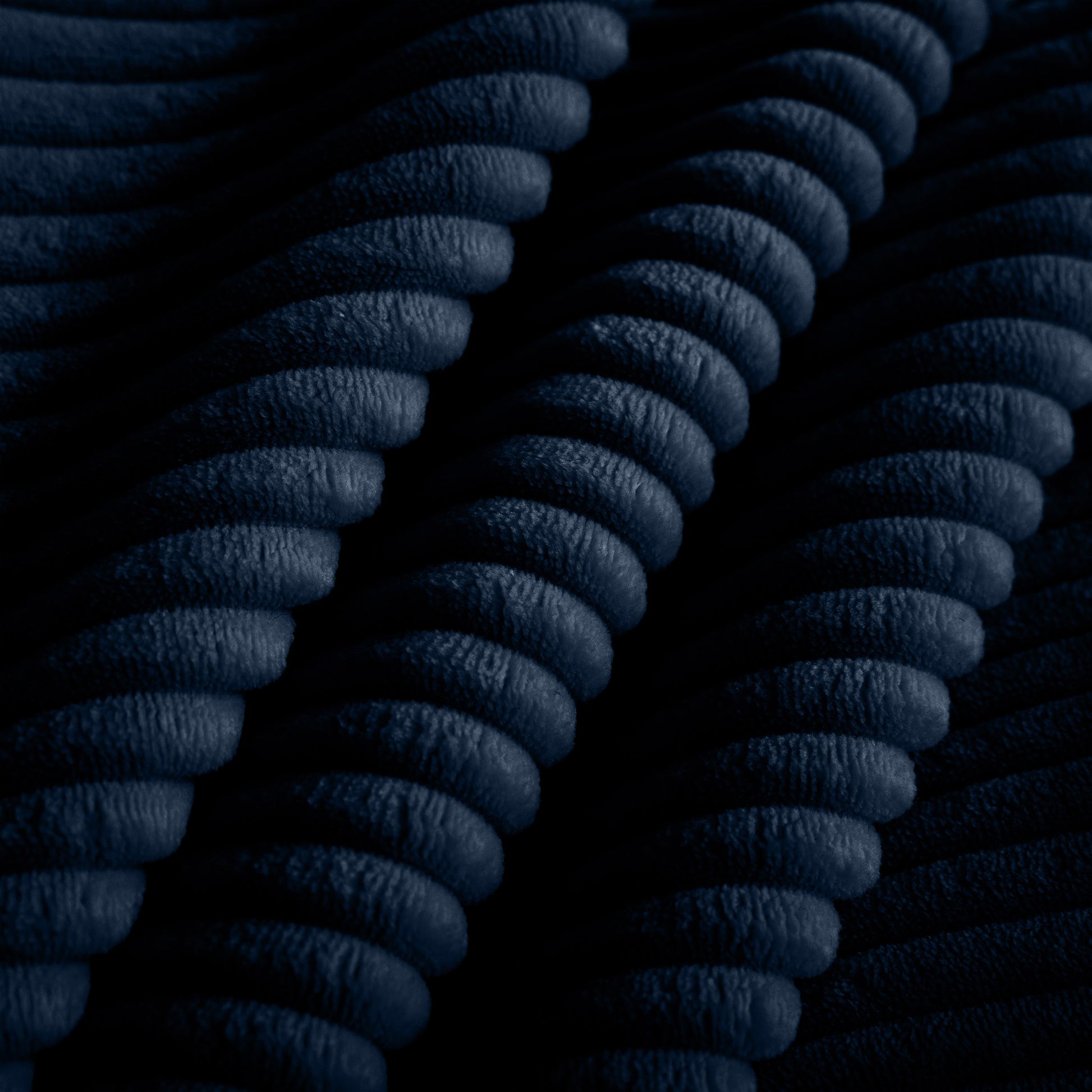Dark navy corduroy fabric texture with pronounced wales
