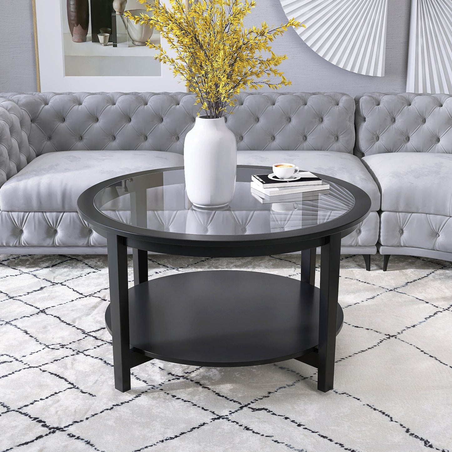 Round black coffee table with glass top and lower shelf