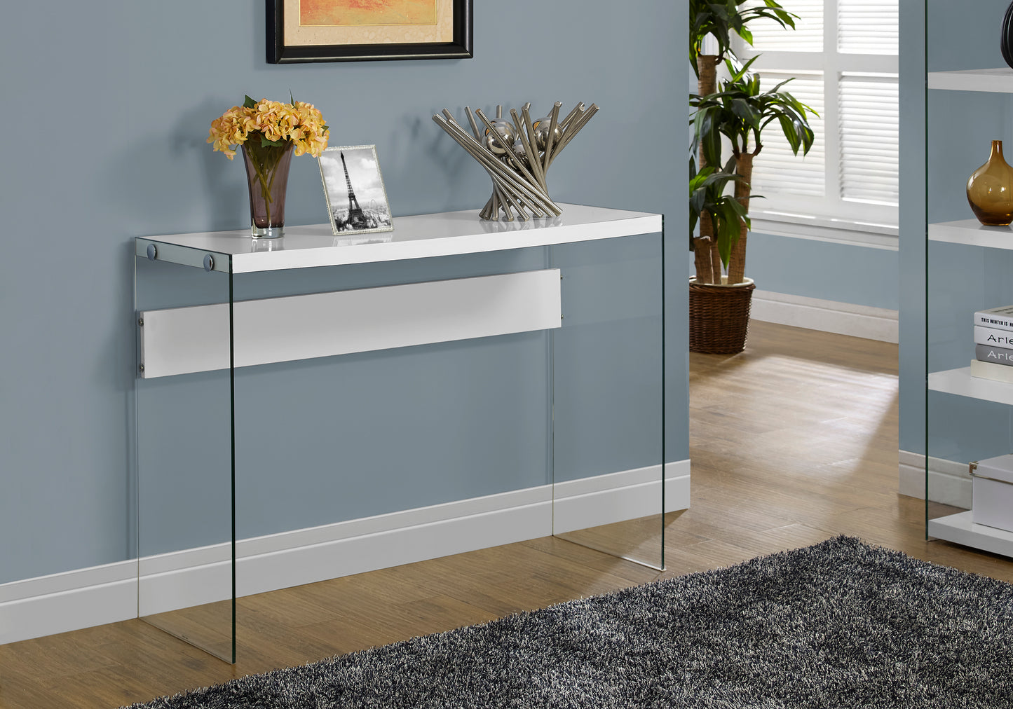 Sleek white console table with clear glass legs and chrome accents for modern living rooms