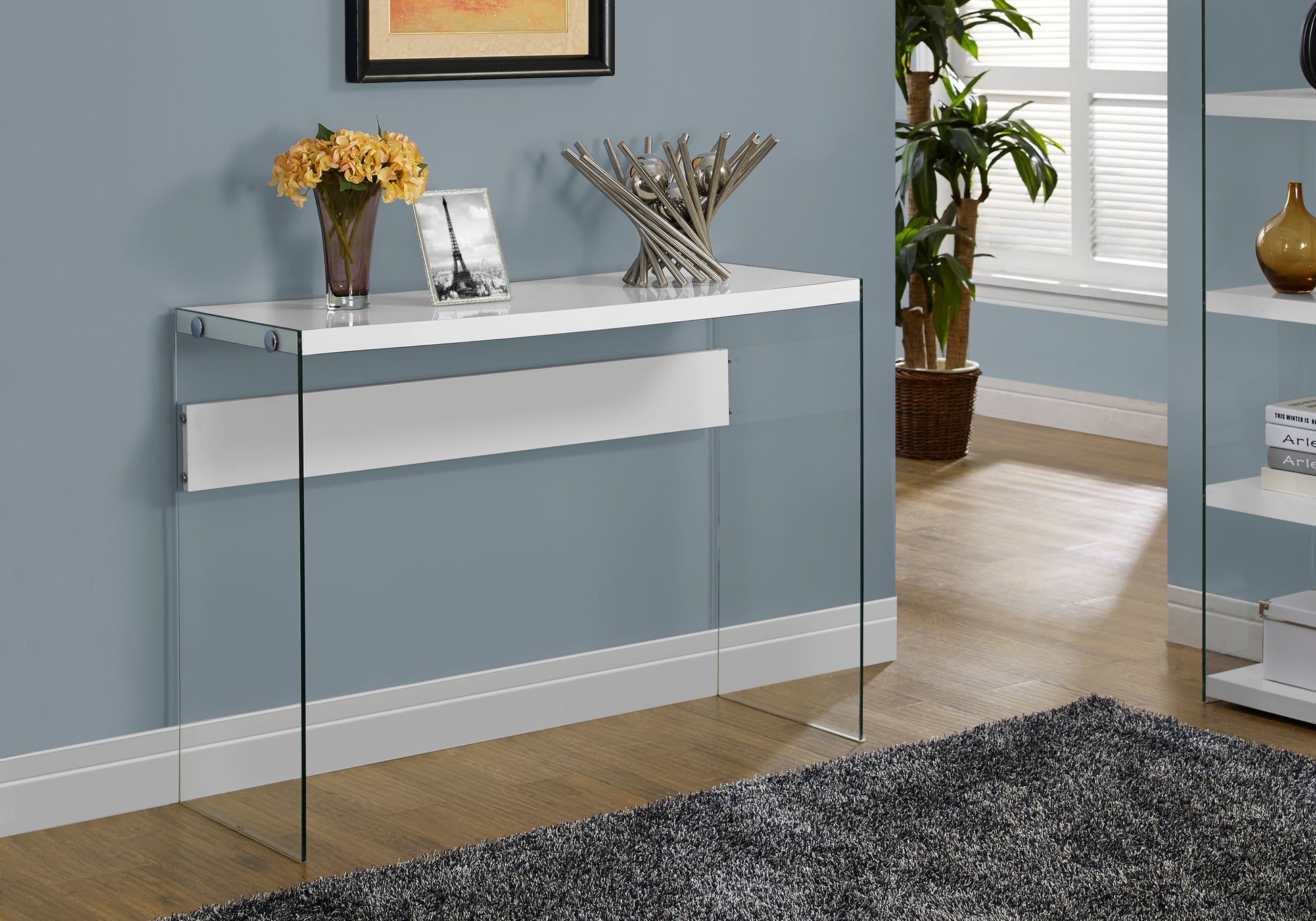 Sleek white console table with clear glass legs and chrome accents for modern living rooms