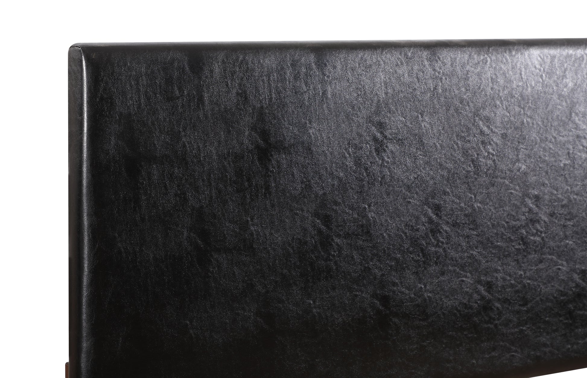 Closeup of a textured black faux leather headboard providing a luxurious feel