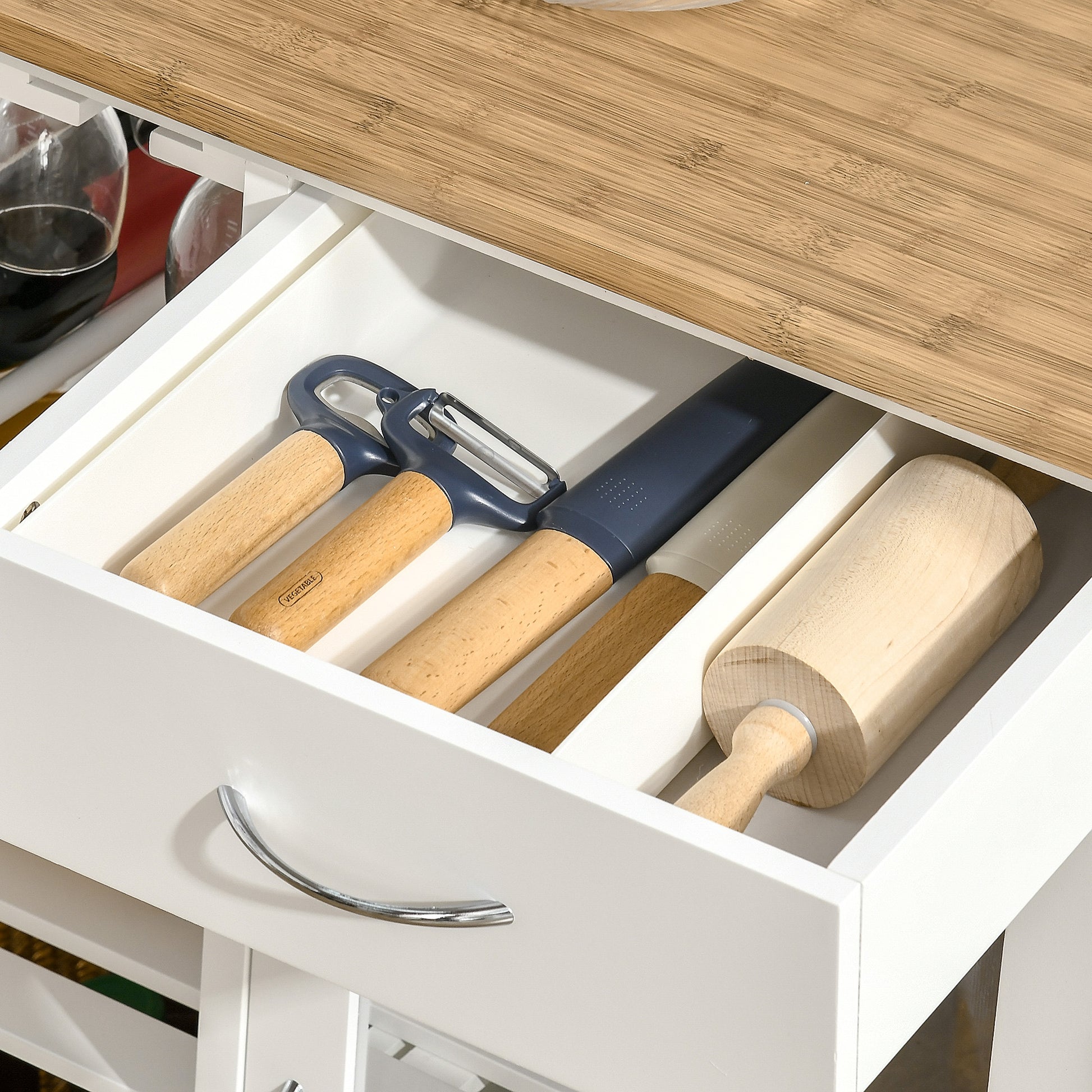 Wooden handled peeler and knife set with blue accents in kitchen drawer