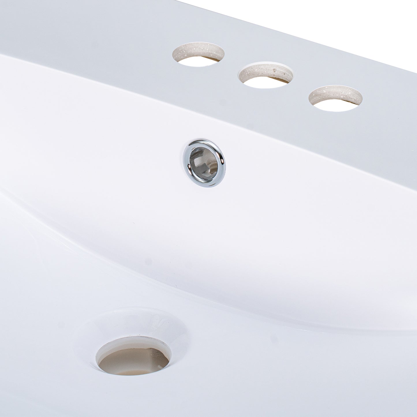 White ceramic sink with three faucet holes and a chrome drain fitting