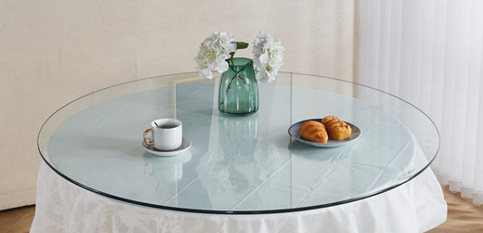 Round glass tabletop with white tablecloth a teacup and pastries for elegant dining