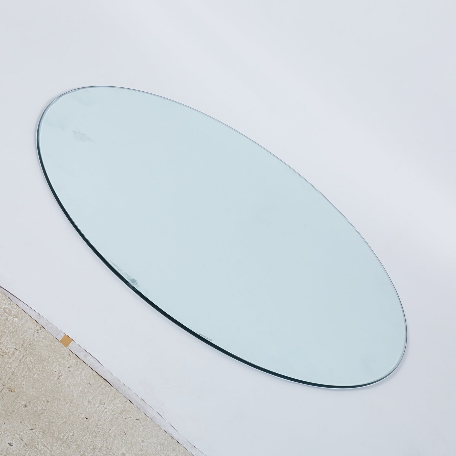 Clear oval glass tabletop with polished edge for dining