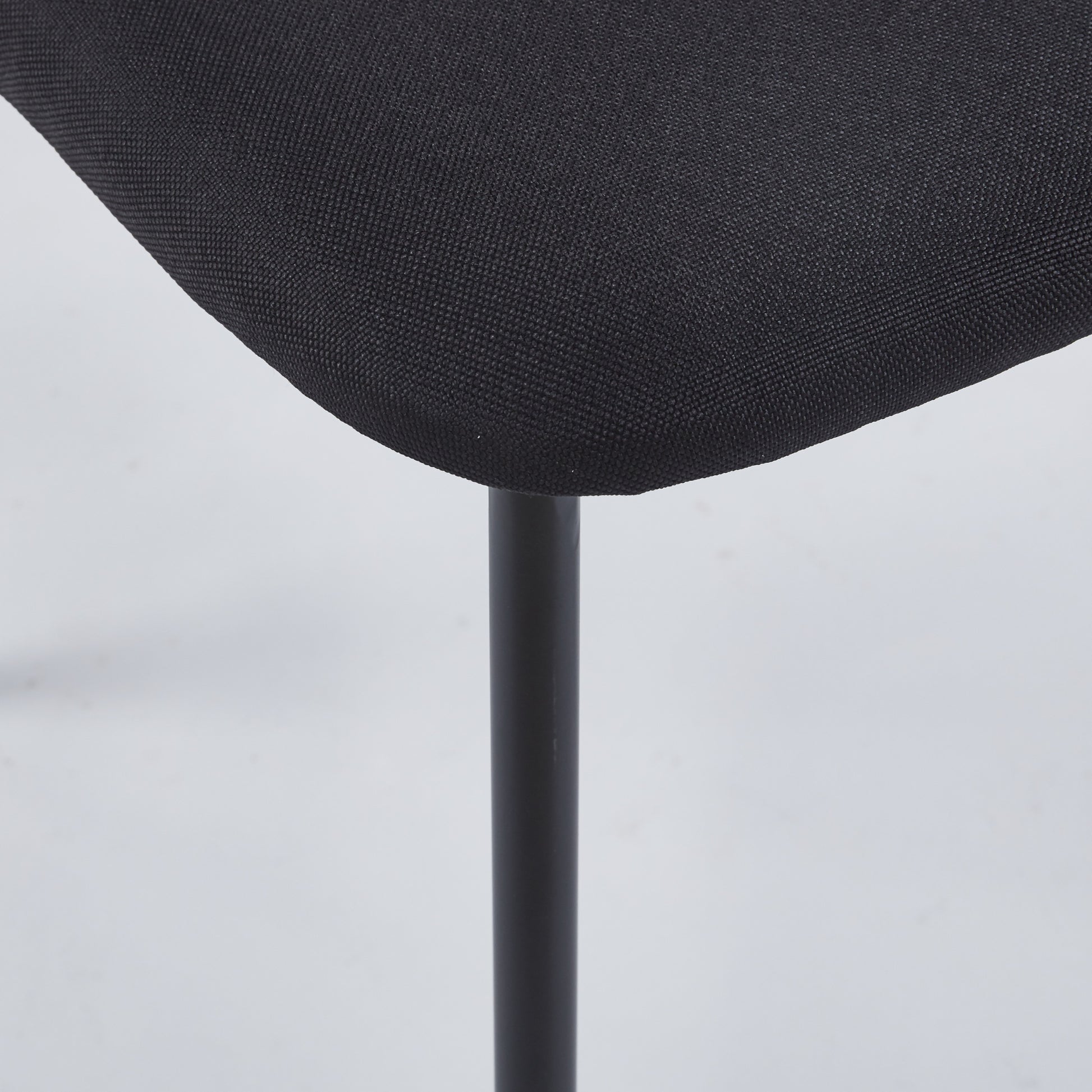 Closeup of black fabric upholstery on a modern office chair base