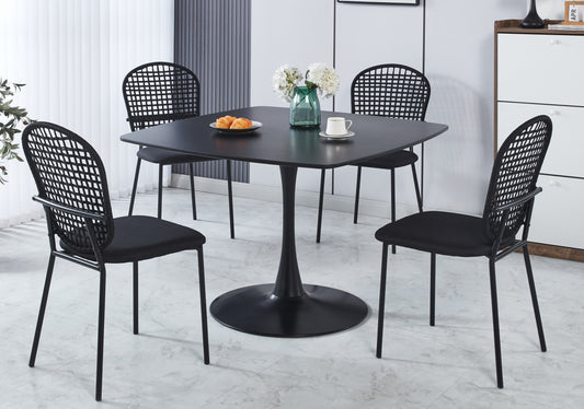 Modern black tulip dining table with four contemporary rattan chairs for seating