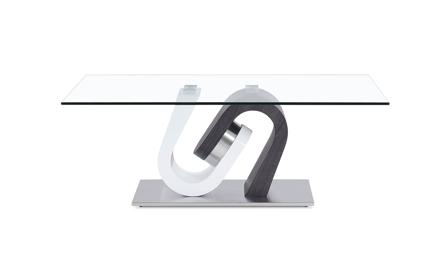 Modern glass coffee table with a sculpted white and dark wood base on a brushed metal stand