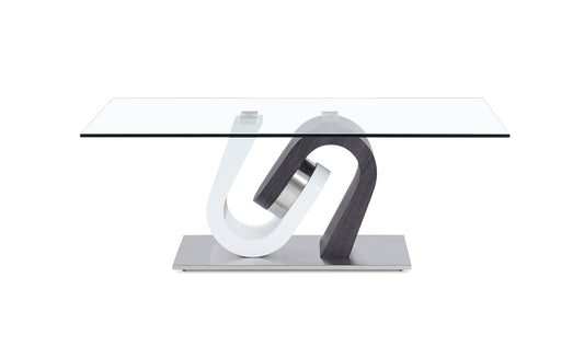 Modern glass coffee table with a sculpted white and dark wood base on a brushed metal stand