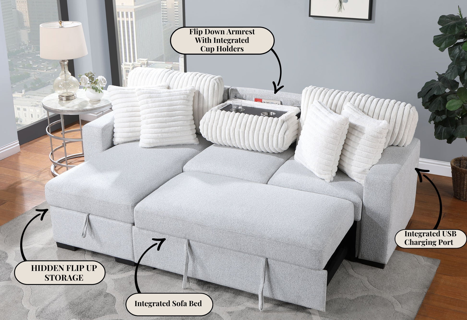 Light grey fabric sectional sofa with plush white accent pillows and an integrated sofa bed feature