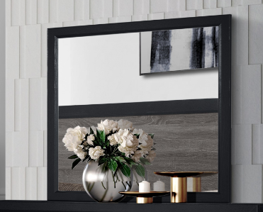 Black framed vanity mirror with reflective surface and floral arrangement
