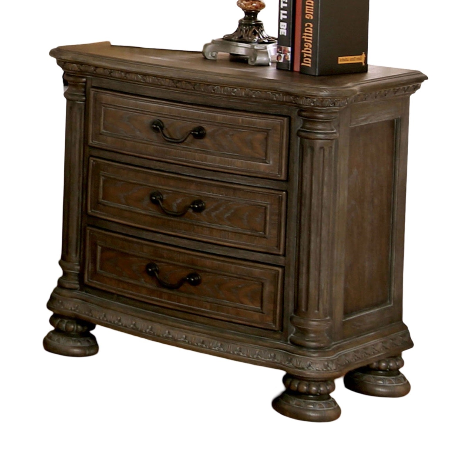 Ornate dark wood nightstand with three carved drawers and decorative legs