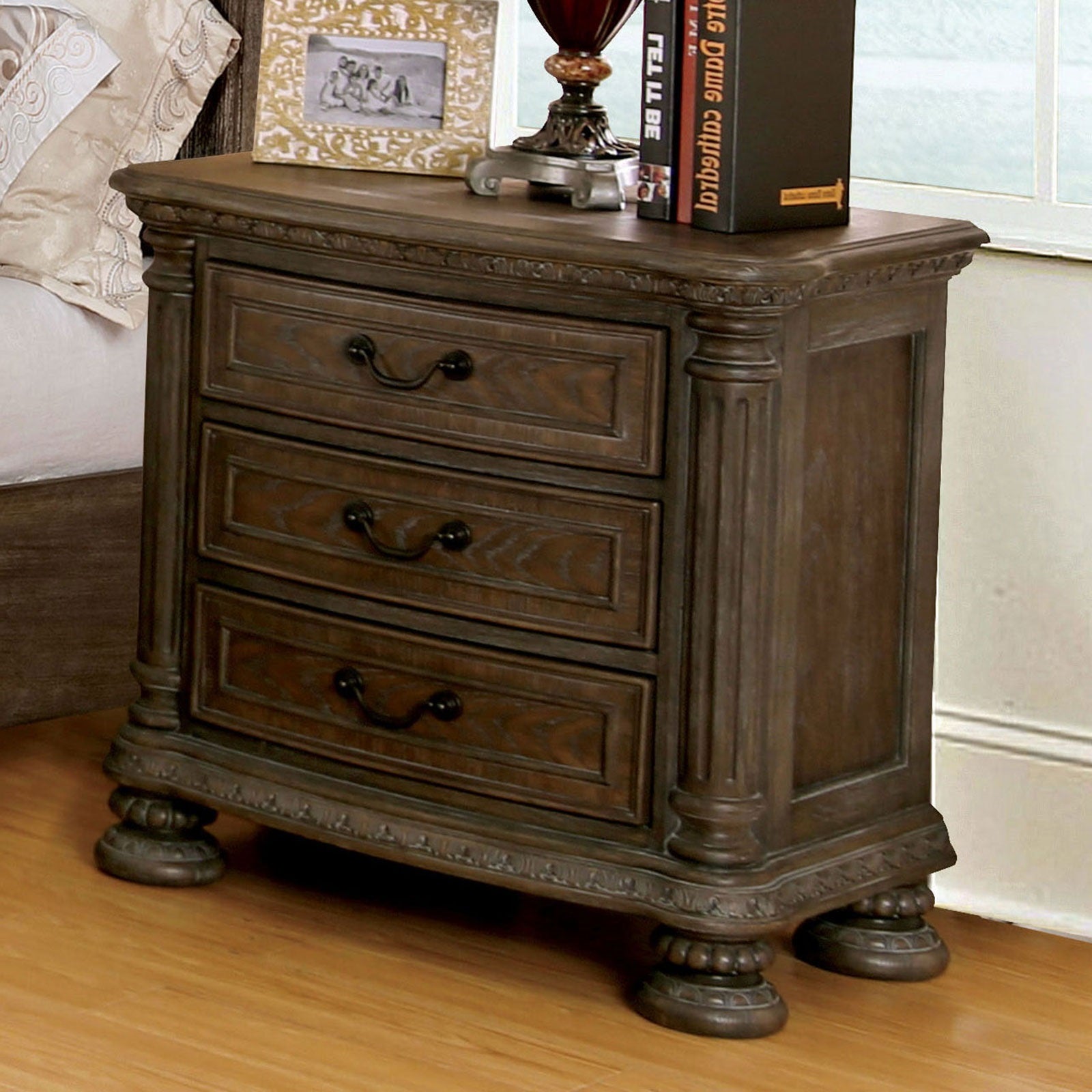 Dark wood vintage nightstand with three drawers and ornate detailing
