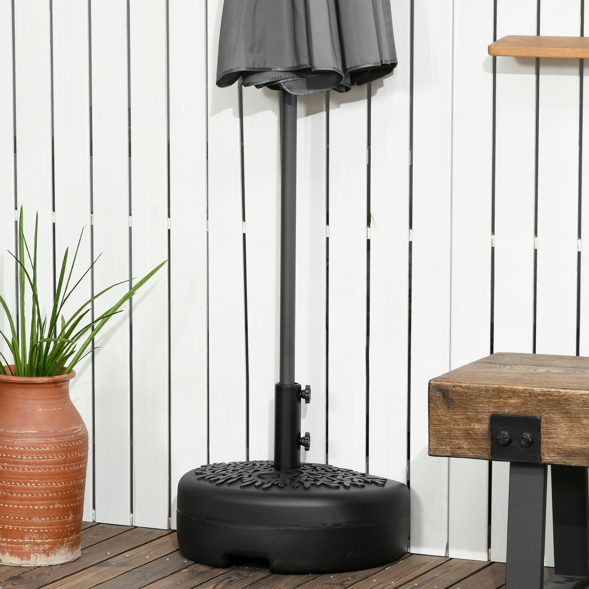 Black patio umbrella base with decorative leaf pattern ideal for outdoor use