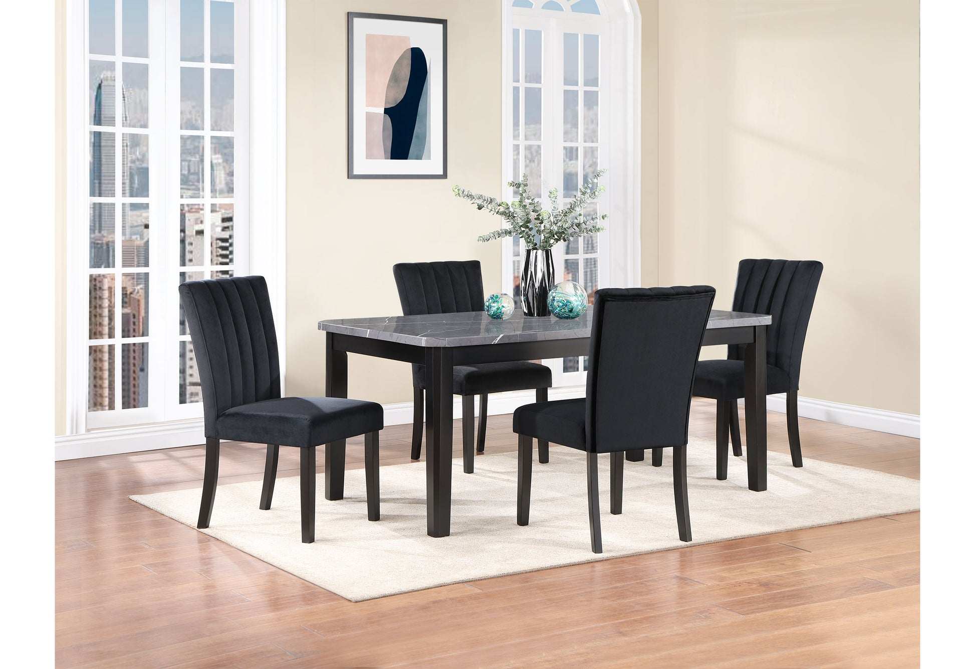 Black velvet dining chairs with fluted backs arranged around a marbletop dining table