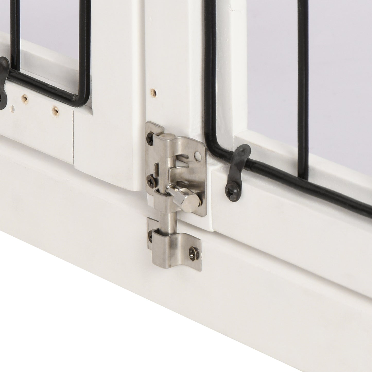 White wooden pet gate with silver bolt latch and black metal bars
