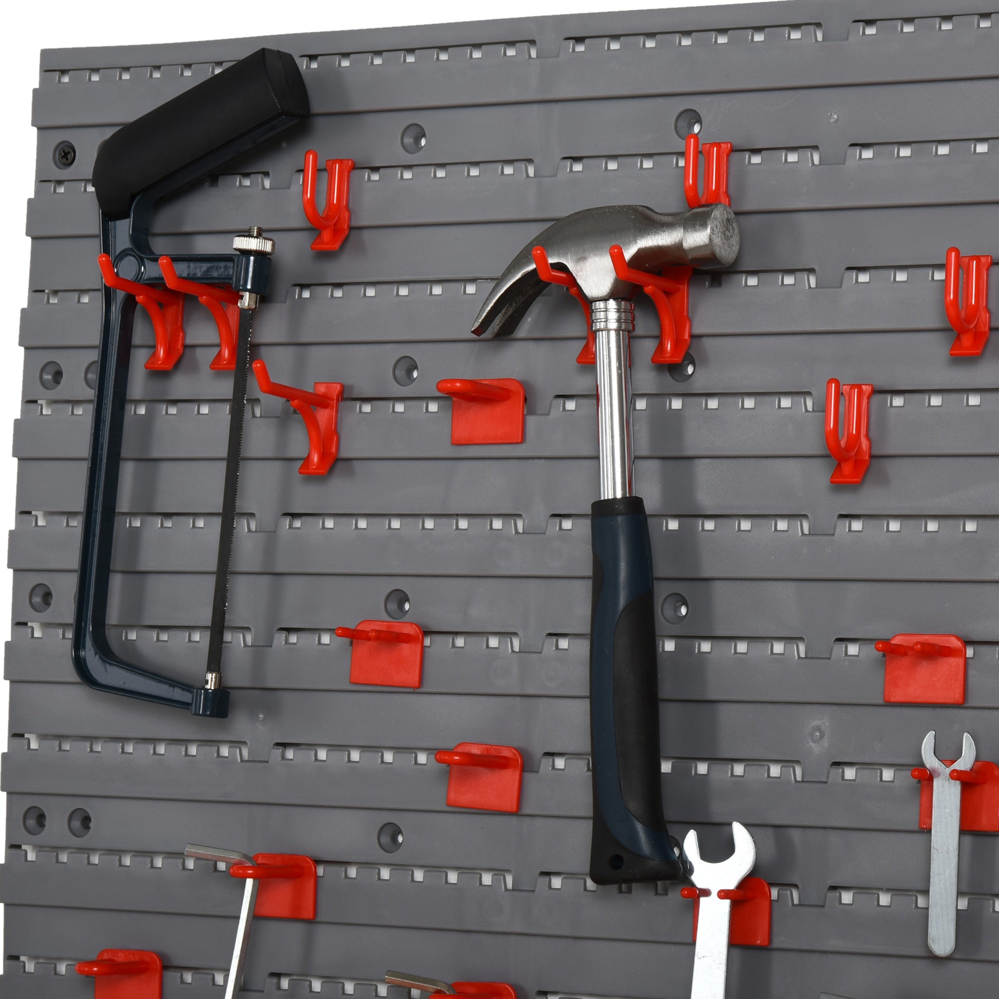 Gray modular pegboard with a hacksaw claw hammer and wrenches on red hooks