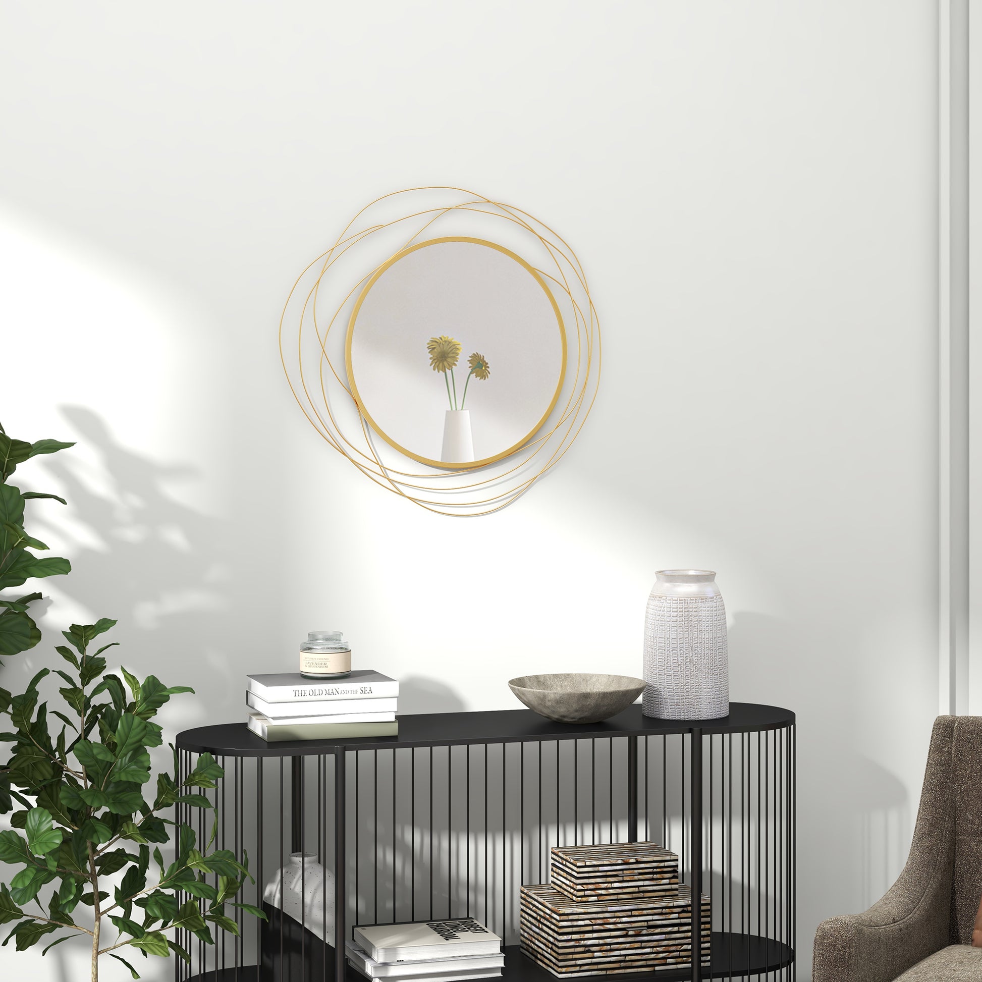 Abstract gold metal wall mirror with concentric circular design and a white vase with yellow flowers reflecting