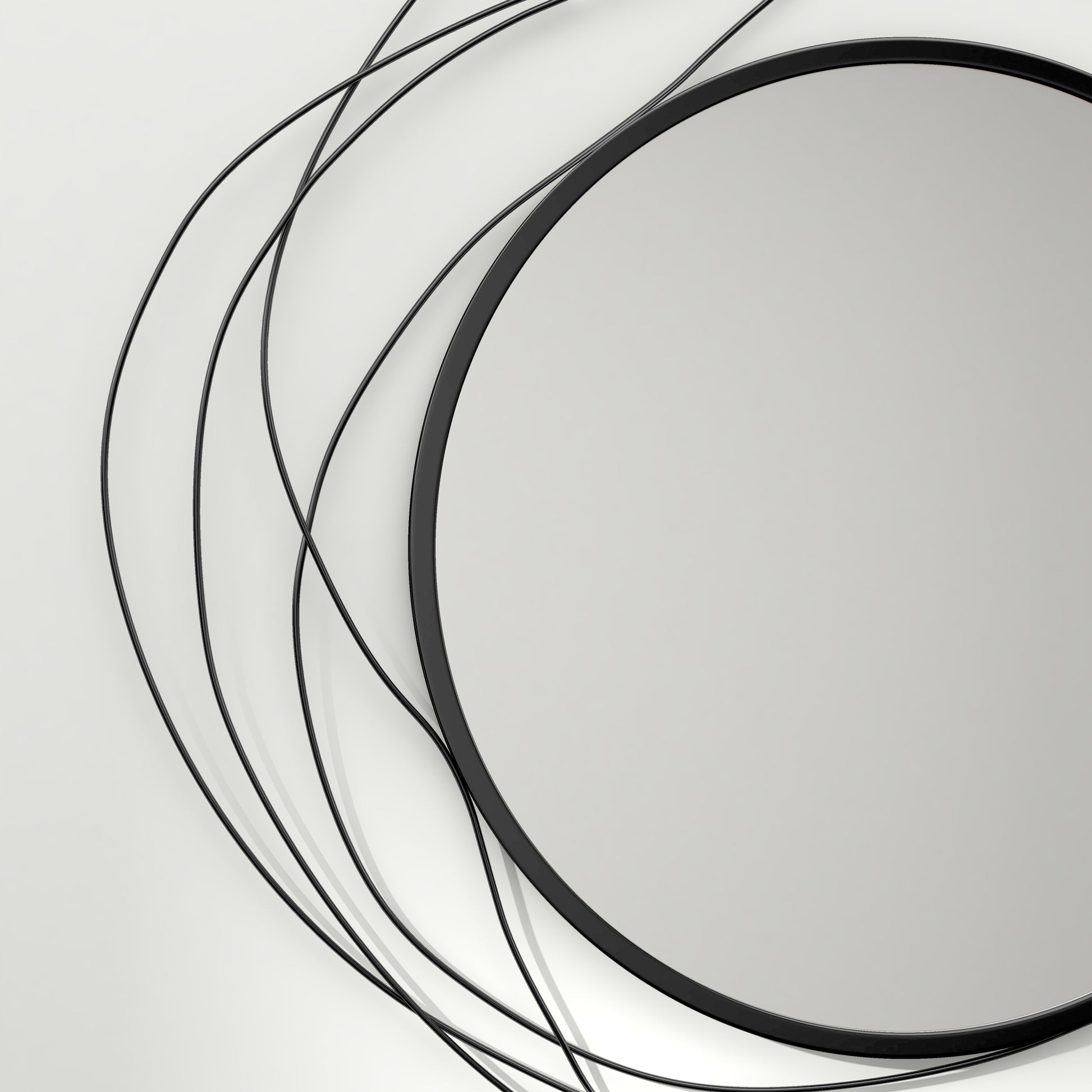 Round black metal abstract wall mirror with swirling wire accents