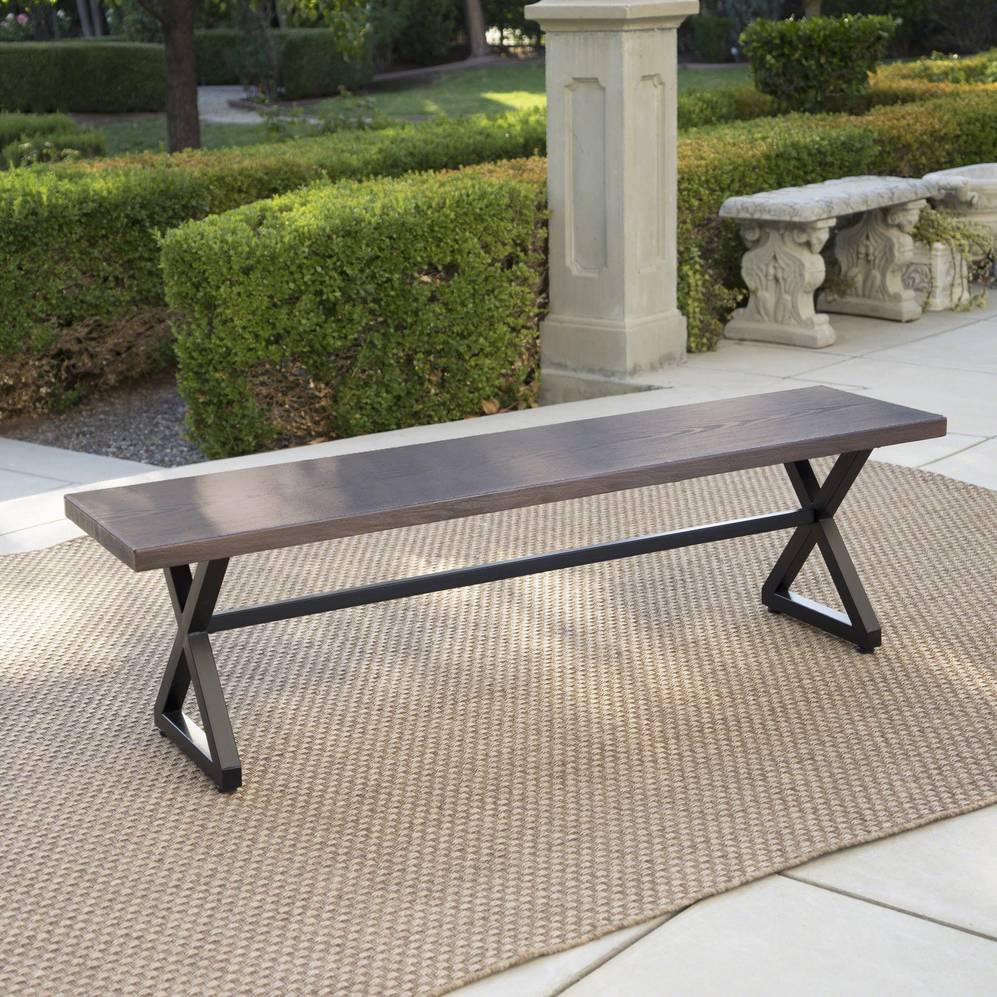 Dark wood and metal outdoor bench with crisscross legs perfect for patio seating
