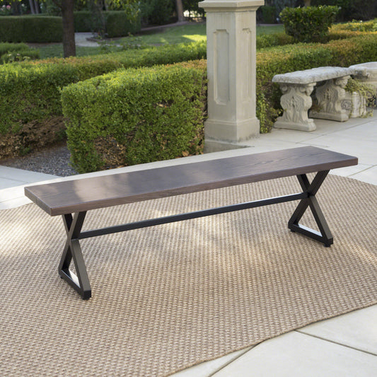 Dark wood and metal outdoor bench with crisscross legs perfect for patio seating