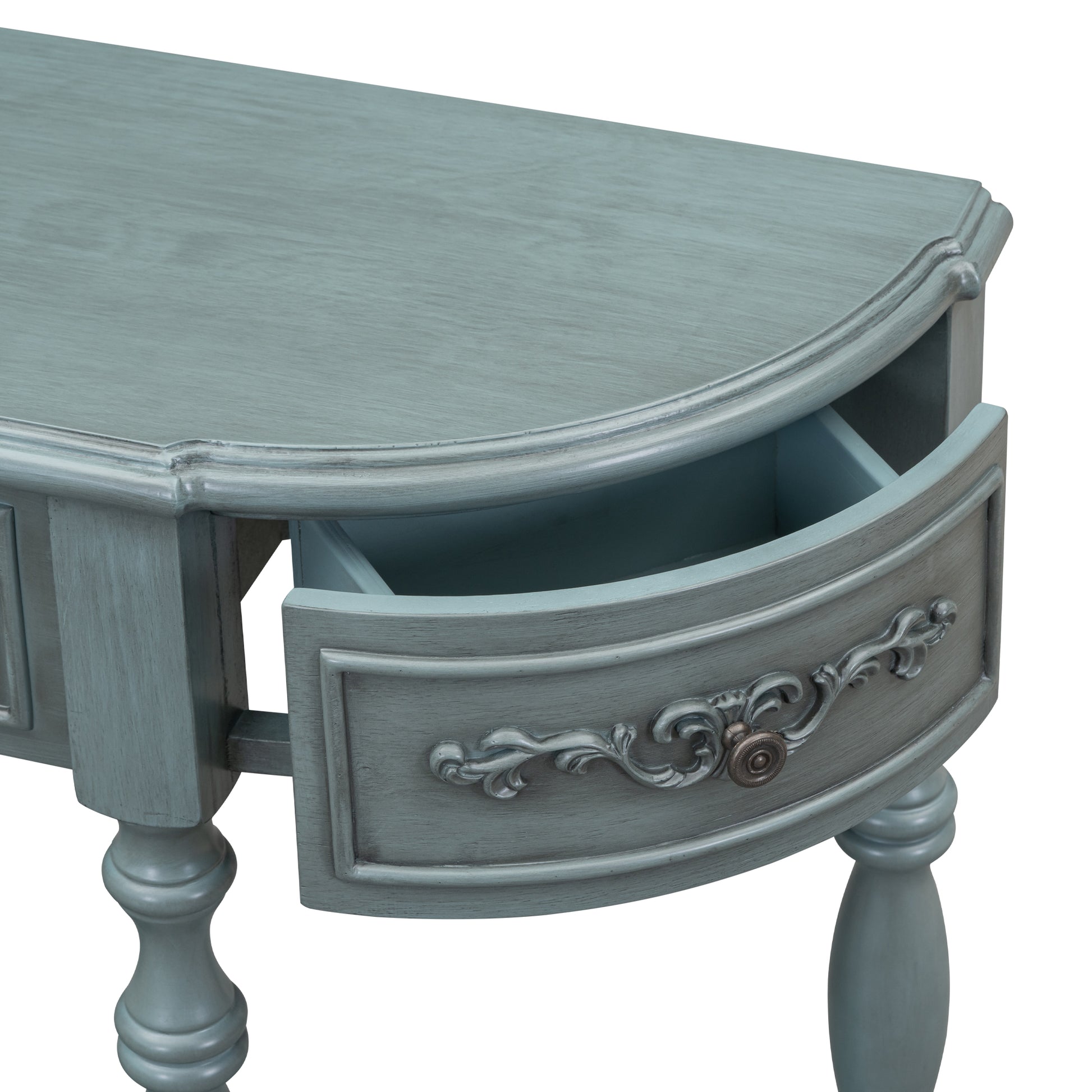 A dusty blue vintage console table with an open drawer and ornate detailing