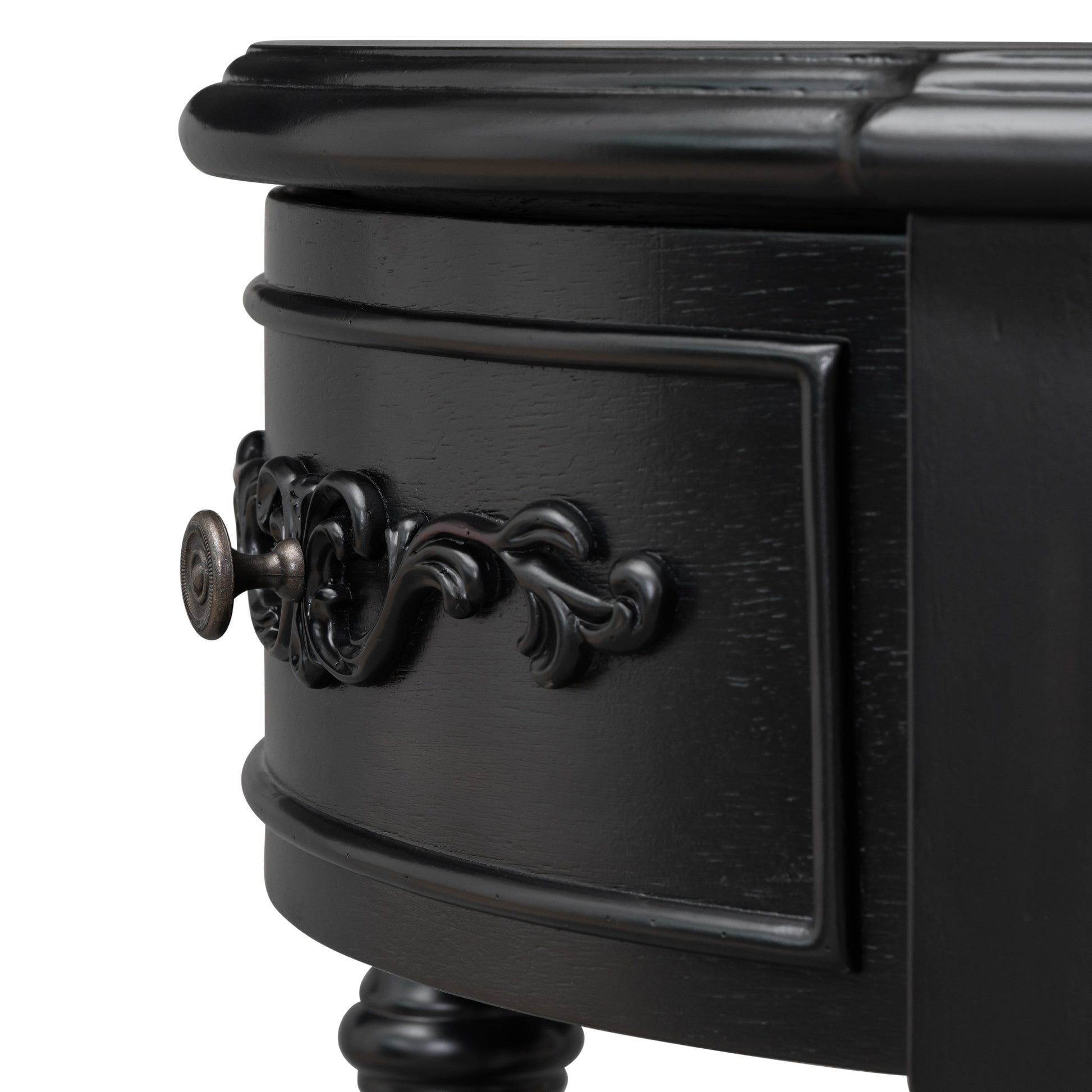 Black ornate drawer pull on a distressed wood side table