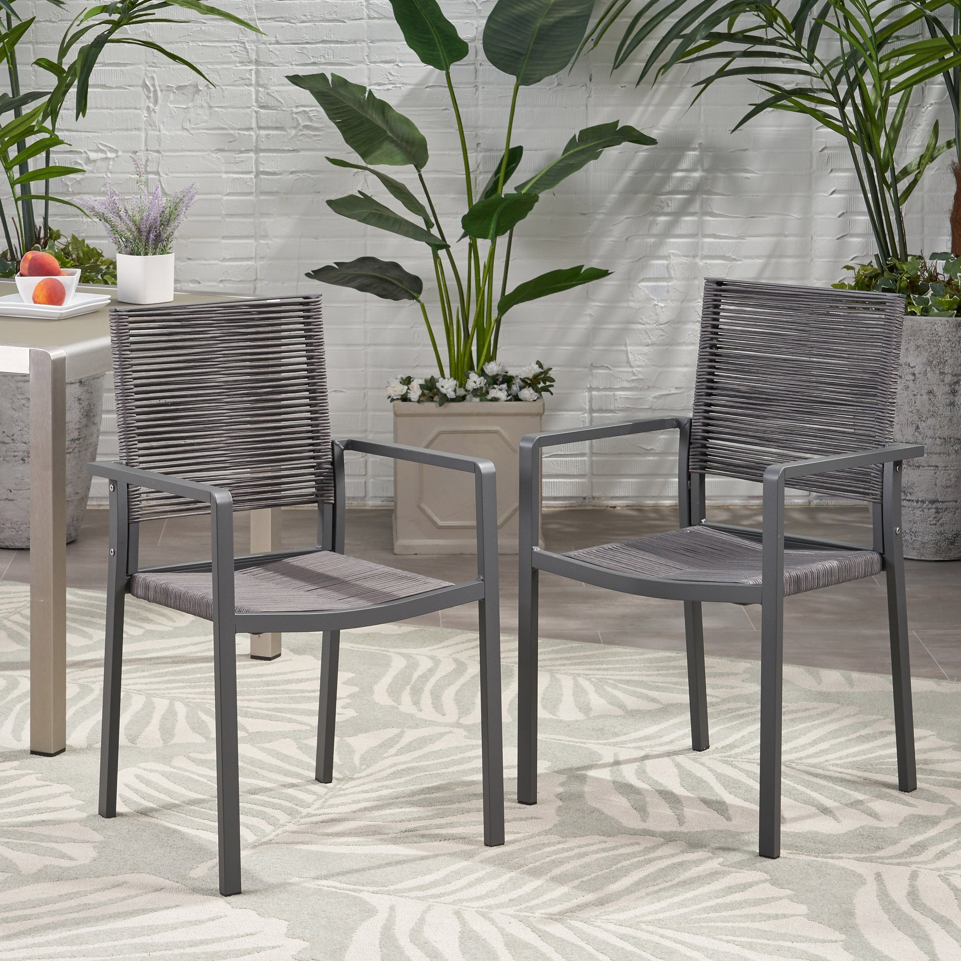 Two grey wicker outdoor chairs with metal frames offer a modern comfortable seating solution