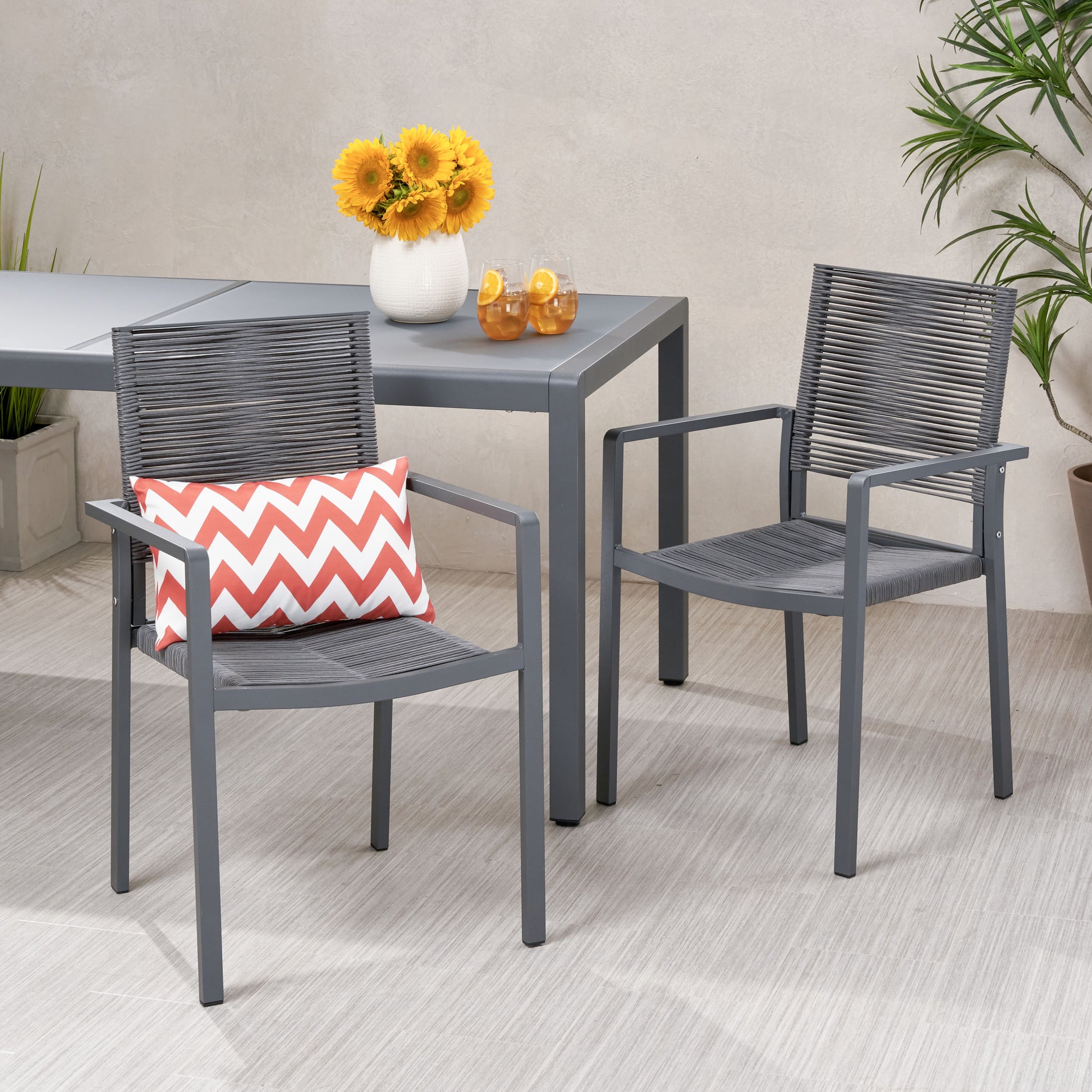Gray metal outdoor dining chair with rope weave back and seat