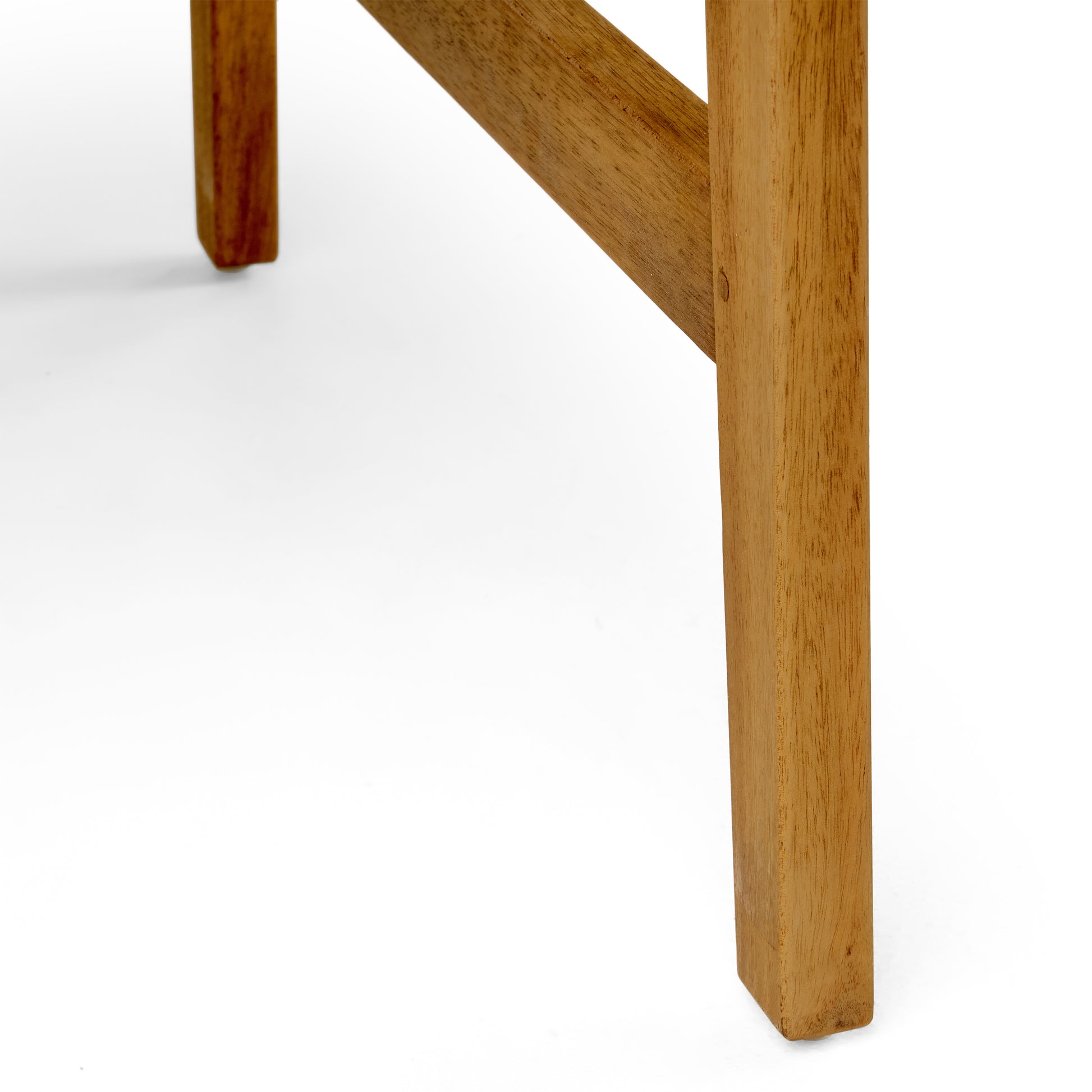 Close up of the angled wooden leg of a rustic coffee table