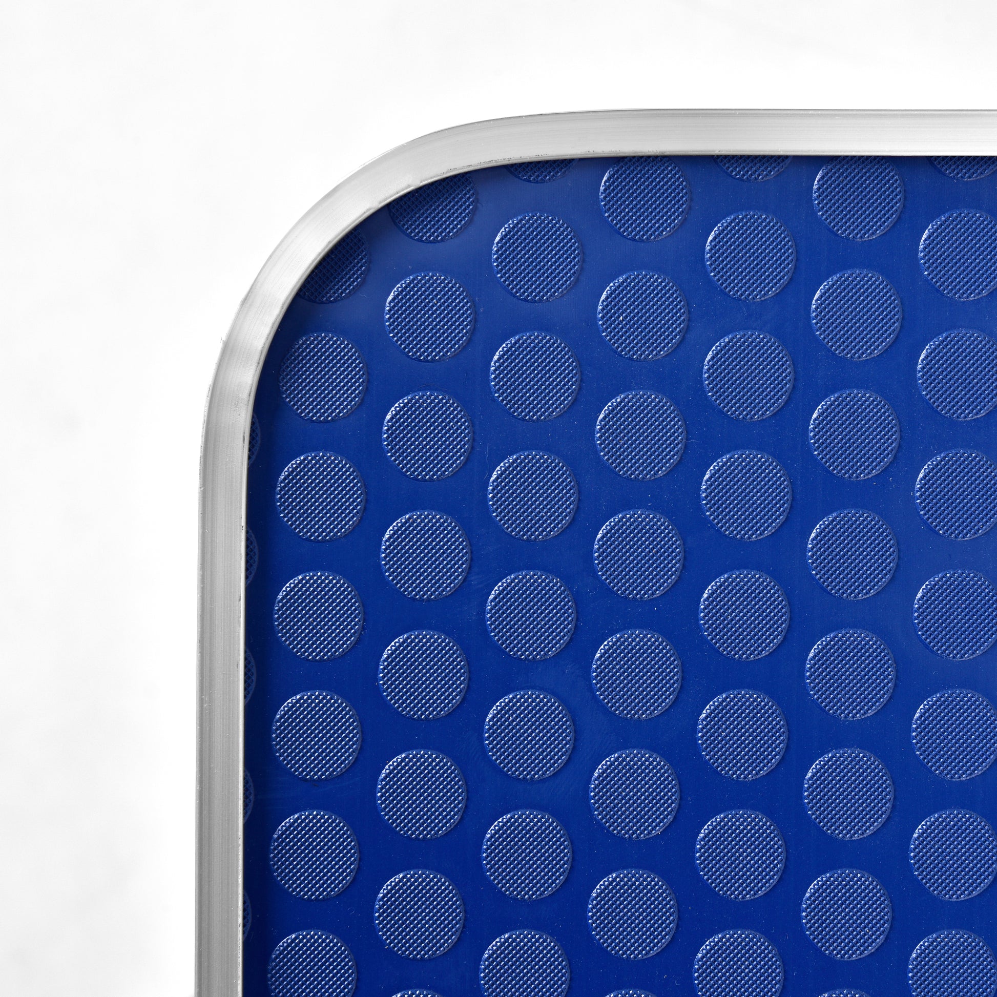 Closeup of a blue mat with raised circular textured patterns perfect for grip