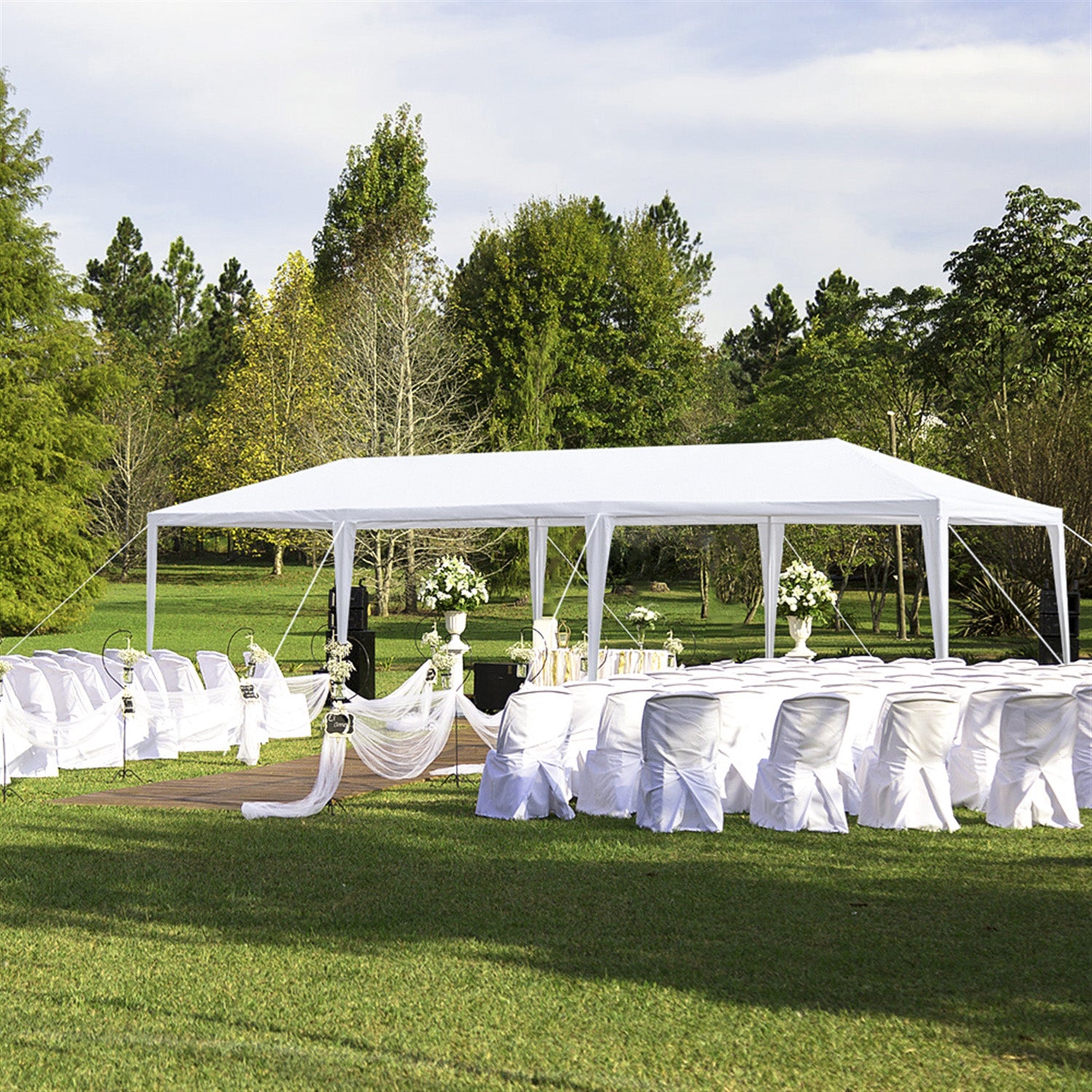 White canopy tent with chairs arranged for an outdoor wedding ceremony on a lawn