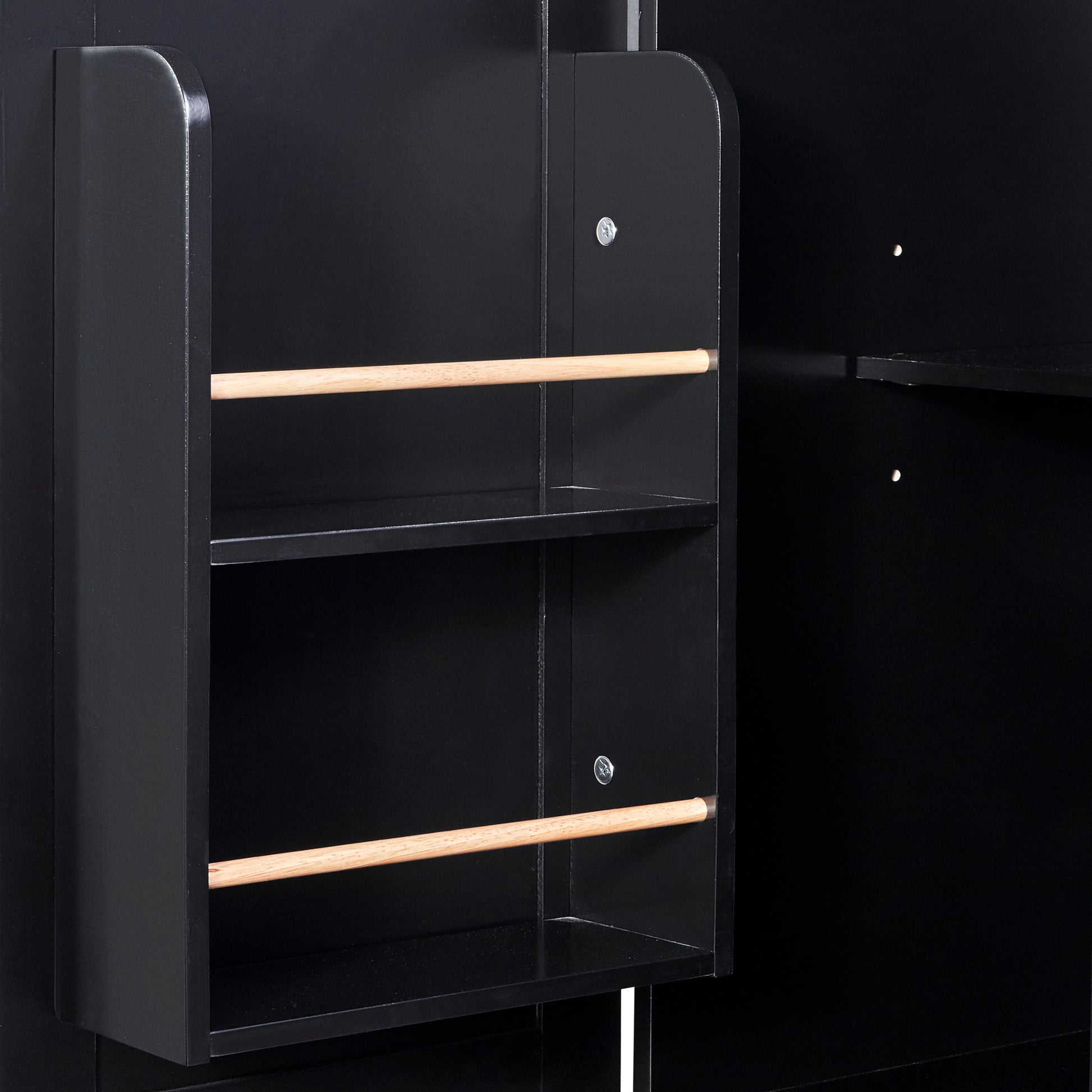 Closeup of a black wooden shelf unit with two parallel wooden dowels supporting shelves