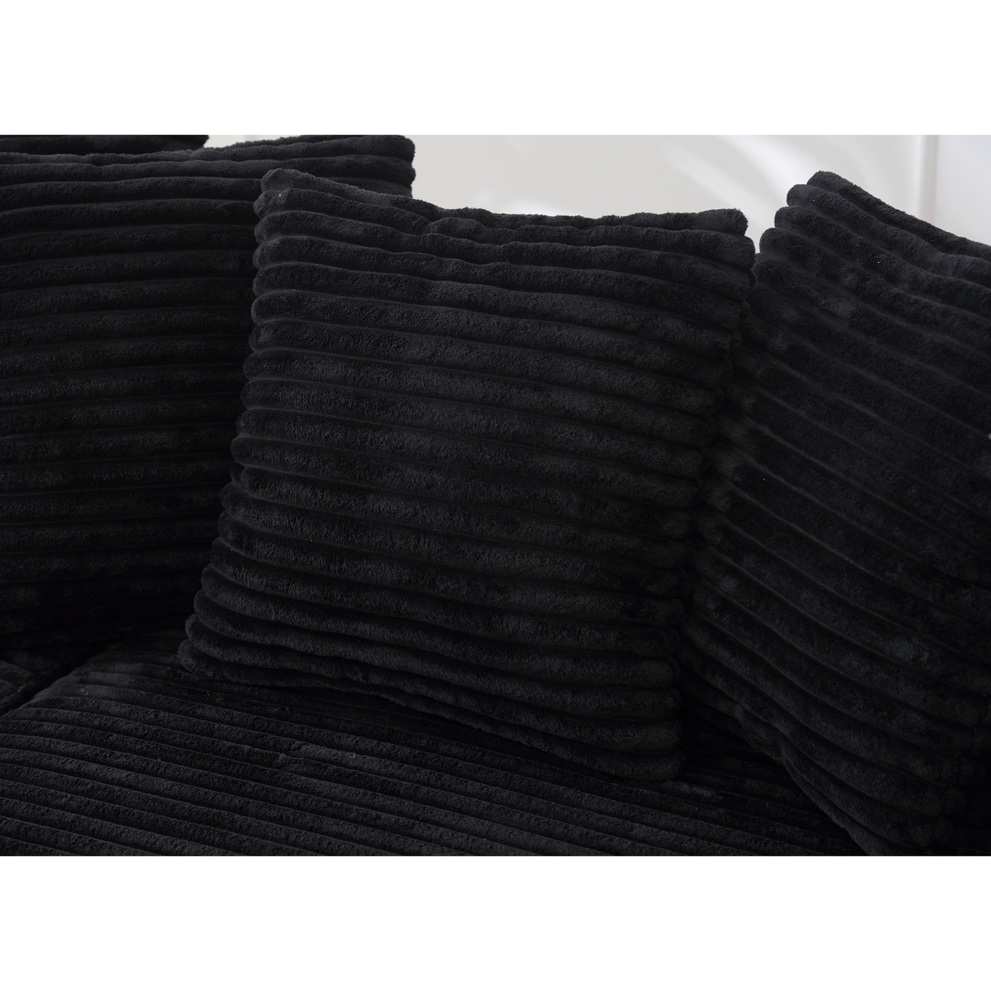 Plush black corduroy throw pillow with horizontal ribbing for a cozy feel